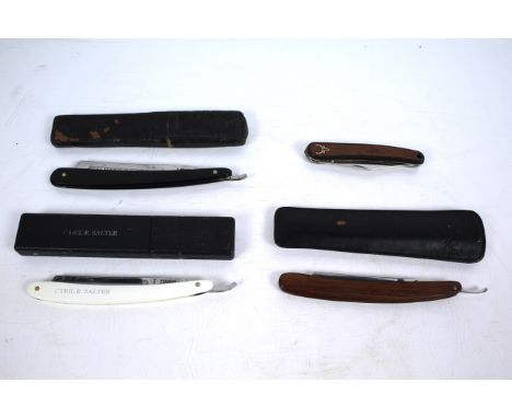 Three cutthroat razors including the Exhibition Razor Newcastle on Tyne 1887 by R. McQueen &amp; Sons with a stag Ireland fol