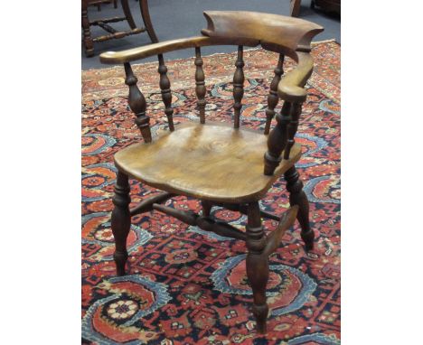 A 19th century elm seated smoker's bow armchair  