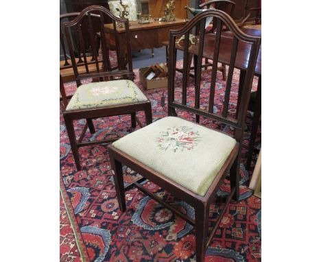 A set of five George III mahogany stick back dining chairs, to include a carver  