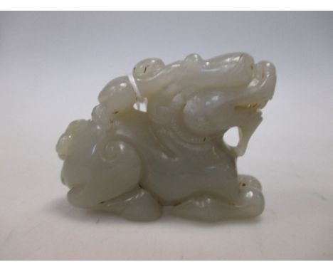 A Chinese jade group of a child riding a mythical beast  