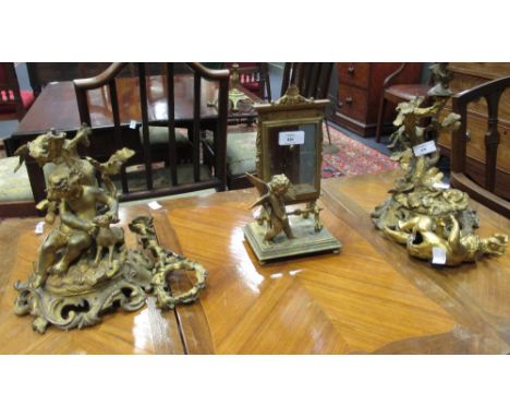 2 metal ornaments of boys sitting with sheep. gold coloured, together with a similar mirror and a brass table lamp (4)  