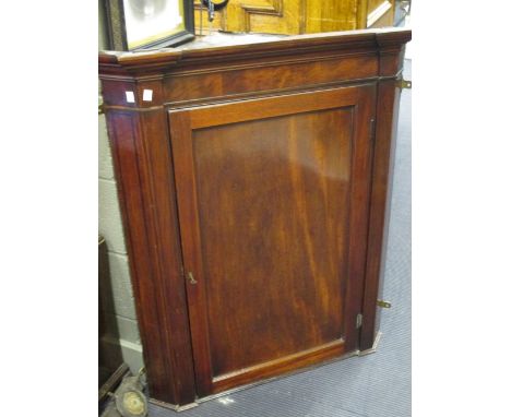 A George III mahogany hanging corner cupboard, and a George III mahogany bow fronted serving table (2)  