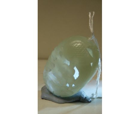A Chinese pale green nephrite jade hollowed ovoid pendant, 5cm (2 in) wide  Good