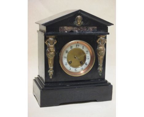 A black slate and marble inlaid mantle clock  