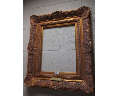 An ornate gilded frame, with Rembrandt self-portrait plaque, sight size 39 x 29cm, overall size 64 x 54cm  Condition is fine.
