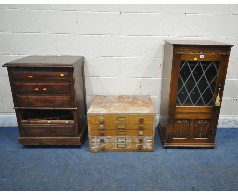 A LATE 20TH CENTURY OAK MEDIA CABINET, with a hinged lid, single lead glazed door, above a linenfold door, width 53cm x depth