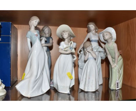 A GROUP OF SEVEN LLADRO AND NAO FIGURES comprising two Lladro figures to include 'Curious Girl with Straw Hat' No. 5009, desi