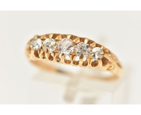 AN 18CT GOLD DIAMOND FIVE STONE RING, set with five graduating old cut diamonds, each in a claw setting, to the scrolling sho