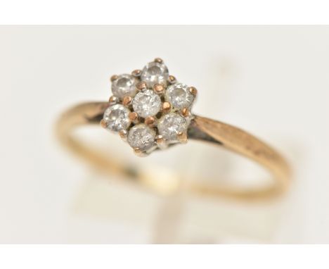 A 9CT GOLD DIAMOND CLUSTER RING, flower shape cluster set with seven round brilliant cut diamonds, in claw settings, stamped 