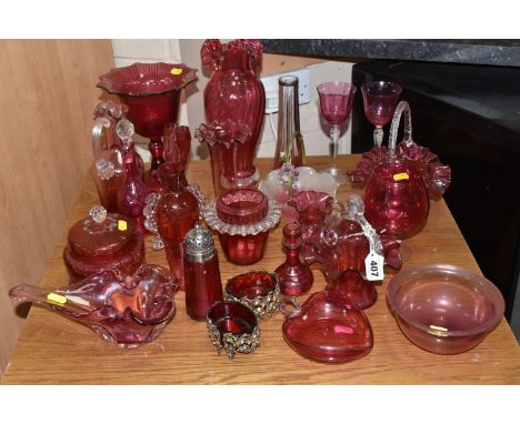 A COLLECTION OF TWENTY-SIX CRANBERRY GLASS ITEMS to include a pair of wine glasses, three baskets (one with visible loss near