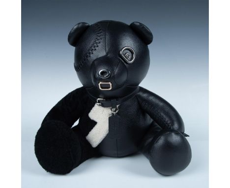 This black leather bear is one tough guy. One arm and his eye patch are whip stitched on. The other arm, leg and half of his 