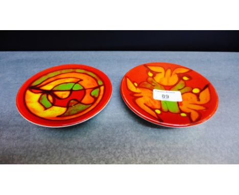 Two Poole Delphis red glazed small circular dishes, 13cm diameter (2) 