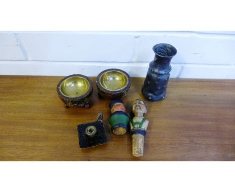 A mixed lot to include a small pewter vase, two painted wood bottle stoppers, a small gilt metal paper stick holder and a pai