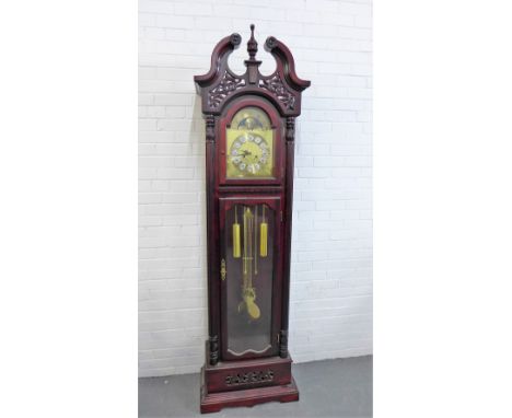 A contemporary hardwood grandfather clock, with broken swan neck pediment and urn finial over a brass dial with Roman numeral