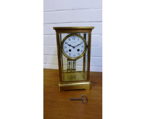 A Wilson & Sharp brass cased mantle clock, the white enamel dial with Arabic numerals, complete with pendulum, 30 x 17cm