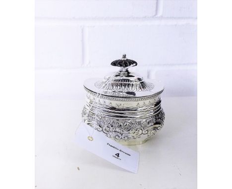 Late Victorian silver sucrier of oval form, with ebonised lid and floral repousee decoration, makers mark for William Gibson,