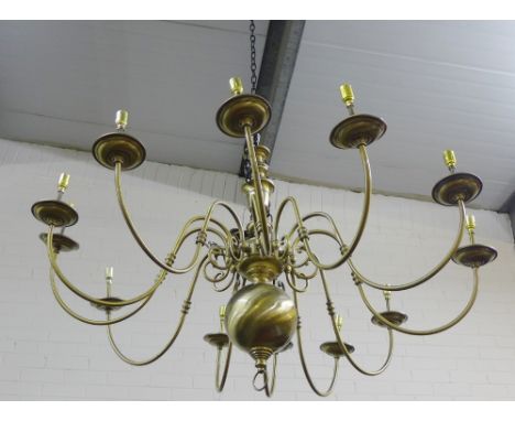A large Dutch style 12 branch brass light fitting, approx 130cm wide 