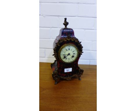 A French tortoiseshell and Ormolu mounted mantle clock, the domed top with a rose finial over an enamelled dial with Roman an