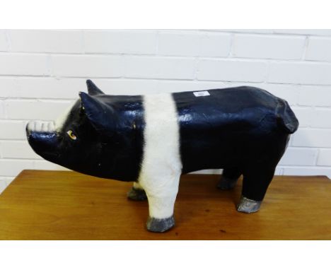 A papier mache model of a black and white pig, 7cm long