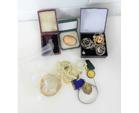 A mixed lot to include a silver Masonic fob medal, a white metal College of Hairdressers fob medal, gilt metal fob medal, two