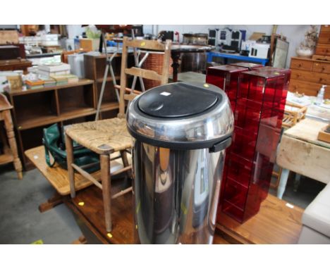 A stainless steal bin; together with a ladder back chair