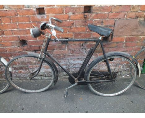A VINTAGE RALEIGH BICYCLE WITH HEAD LIGHT