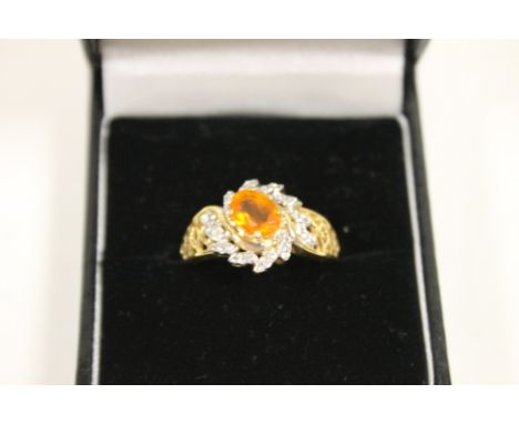 A 9 CARAT GOLD RING SET WITH A FIRE OPAL TYPE CENTRE STONE 