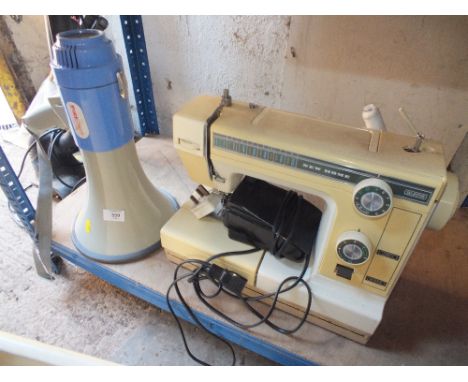 A MEGAPHONE TOGETHER WITH A CASED SEWING MACHINE