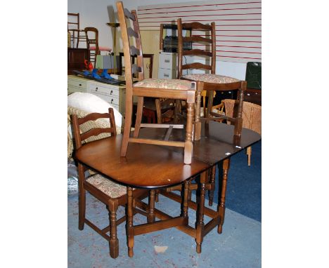 A drop leaf table with four ladder back chairs