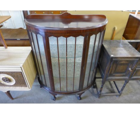 A mahogany bow front display cabinet