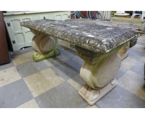 A concrete garden bench