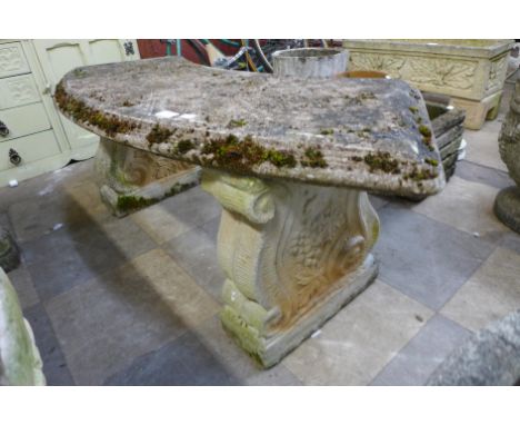 A concrete garden bench