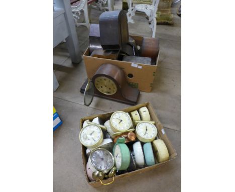 A box of assorted mantel clock cases and parts and a box of assorted alarm clocks
