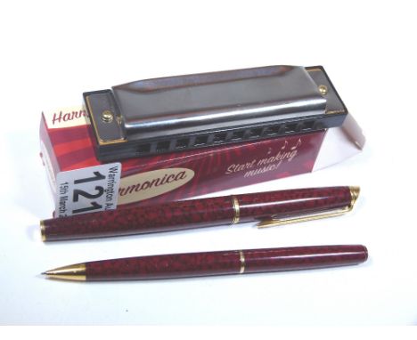 Yellow metal with marbled finish Waterman fountain pen and propelling pencil set and a boxed harmonica 