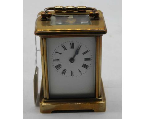 A mid 20th century lacquered brass cased carriage clock having an enamel dial with Roman numerals, visible platform lever esc