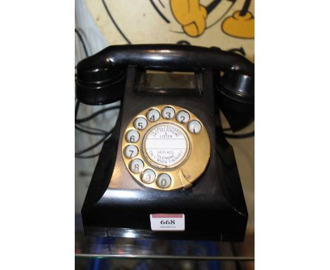 A mid-20th century bakelite rotary telephone 