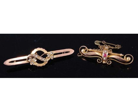An Edwardian 9ct gold, ruby and seed pearl set bar brooch, 38mm, with gilt metal safety chain; together with an Edwardian yel