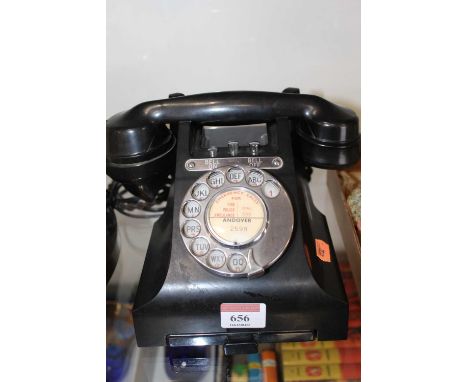 A vintage bakelite rotary telephone 