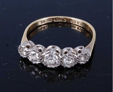 An 18ct gold and platinum diamond five-stone ring, as five illusion set graduated old cuts, the centre stone weighing approx 