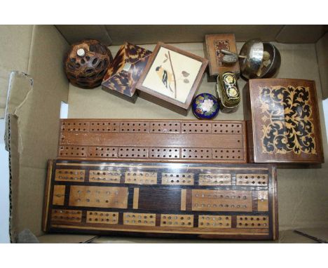 A box containing a collection of various items to include a 19th century tortoiseshell box, cribbage boards, and a cloisonne 