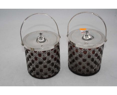 A pair of ruby overlaid and hobnail cut glass biscuit barrels, with silver plated swing handle and covers, h.15cm (excluding 