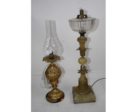 A Victorian oil lamp having a glass font on an onyx column with gilt metal floral mounts and square base, later converted for