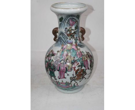 A large Chinese export vase, having a flared rim to a slender neck and bulbous lower body, with elephant head handles, enamel