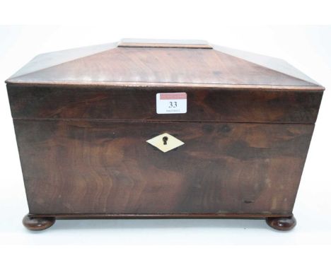 A  Regency mahogany twin compartment tea caddy of sarcophagus form, standing upon four bun feet, width 33cm