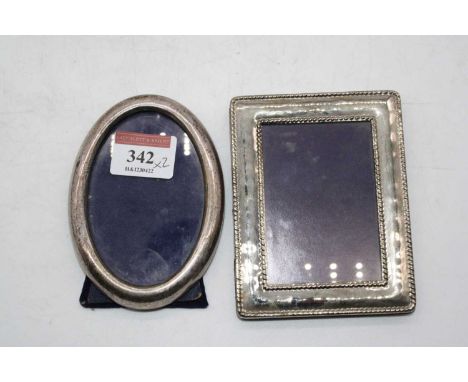 A 20th century sterling silver clad easel photograph frame, of plain undecorated oval form, 10.5 x 8cm; together with one oth