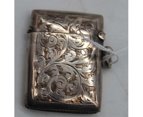 An Edwardian silver vesta, of hinged rectangular form, having all-over foliate engraved decoration and vacant oval cartouche 