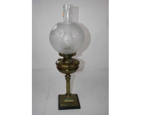 A Victorian brass oil lamp having a globular opalescent glass shade over a  brass font on a fluted column and stepped square 