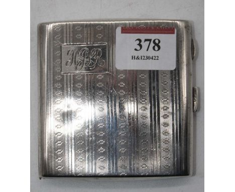 A George V silver pocket cigarette case, having engine turned decoration and monogrammed cartouche, 4oz 