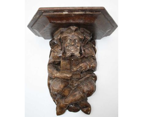 A 20th century figural carved wall bracket in the form of a court jester, 29cm high