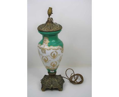 A 20th century green and gilt decorated milk glass table lamp, mounted upon a Rococo style brass base, 63cm high including fi